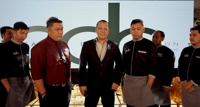 The Casa de Corazon culinary team posed formally in black chef attire