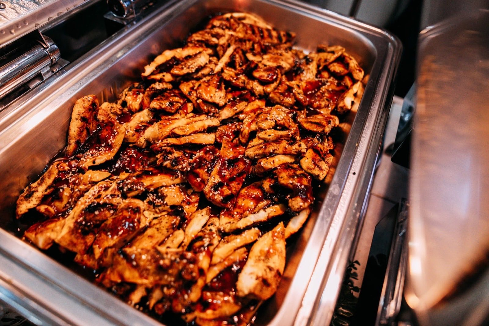 Teriyaki chicken in a catering chafing tray