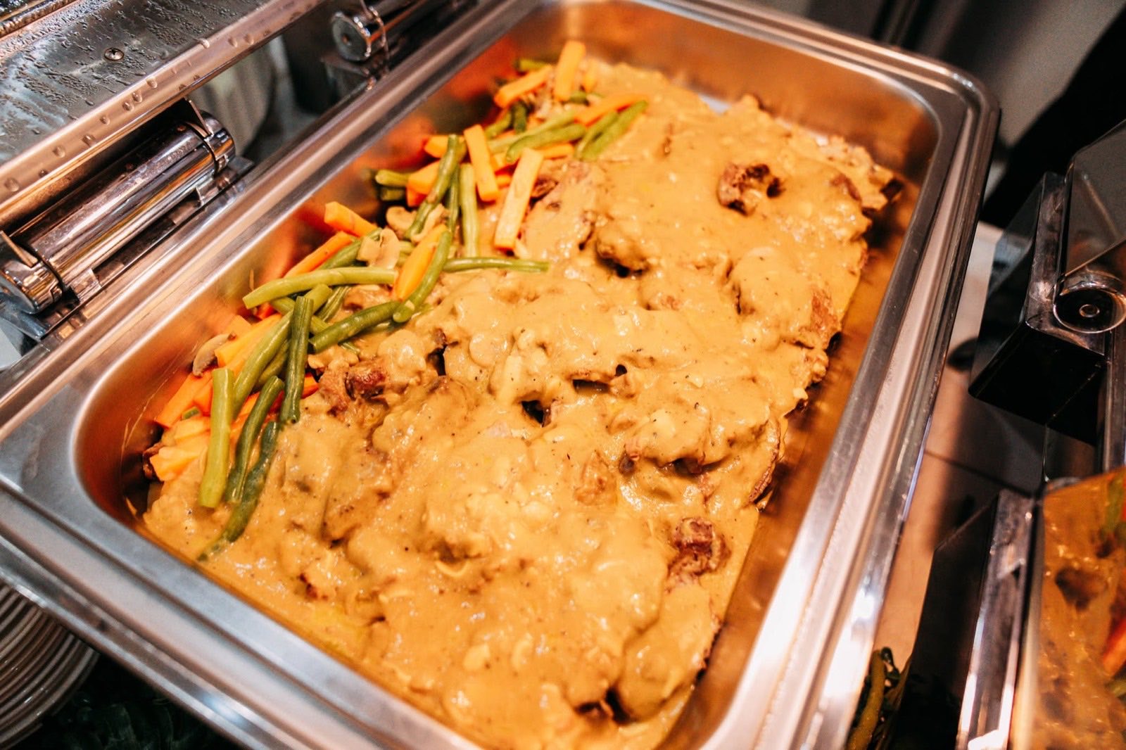 A creamy vegetable dish in a catering tray
