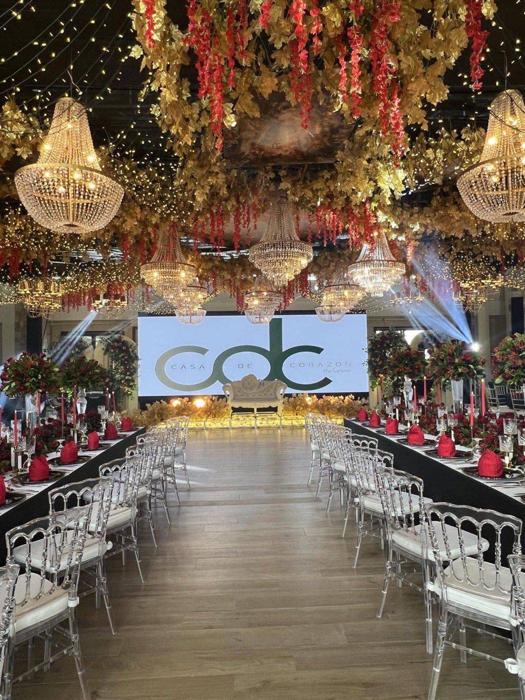 A real Casa de Corazon reception, gold chandeliers and red floral drape